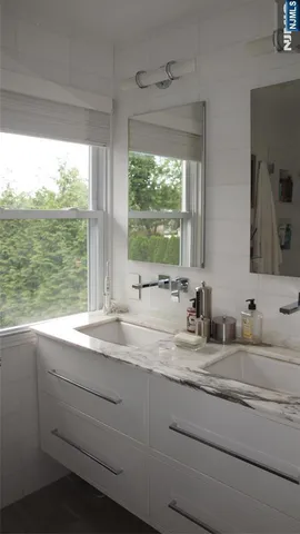 a bathroom with a sink and a large mirror