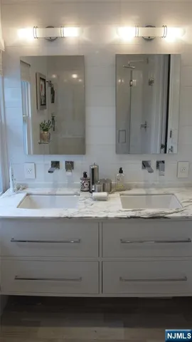 a bathroom with a sink double vanity and a mirror