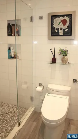 a bathroom with a toilet and a shower