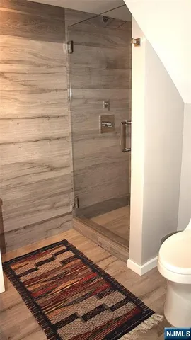 a bathroom with a toilet and a shower