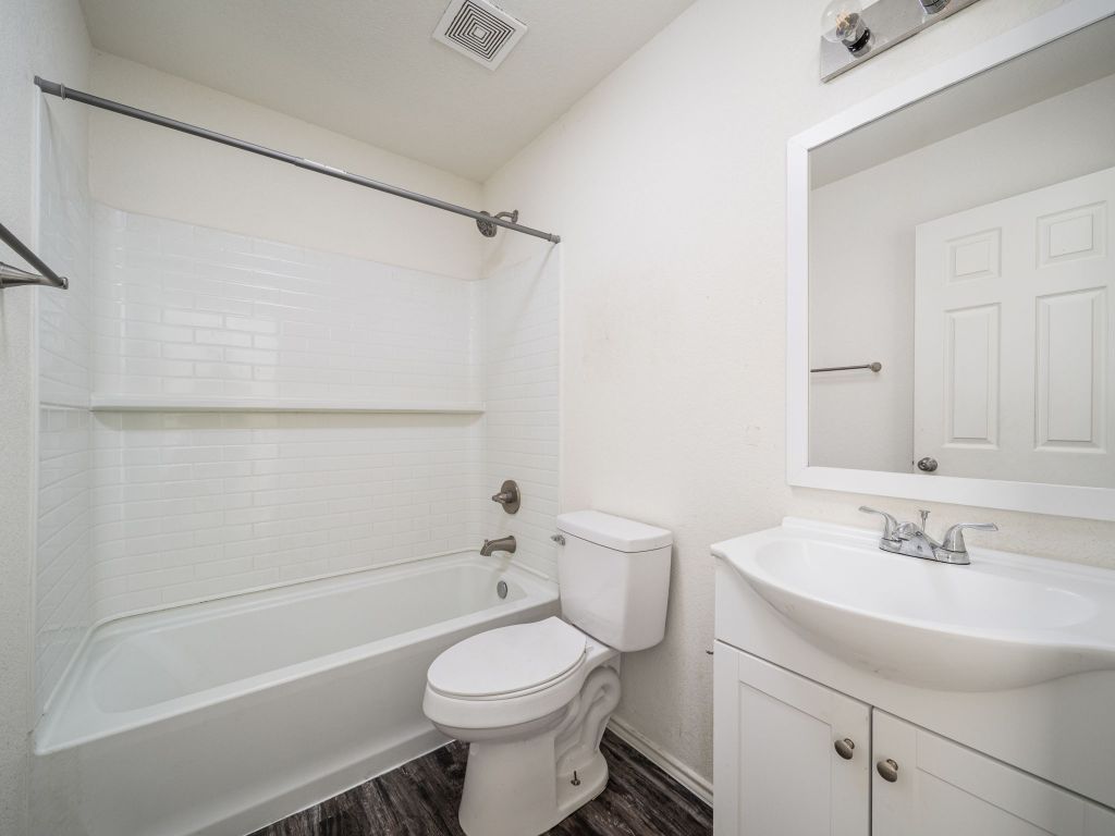 230 Debus Drive, Unit 101B Taylor, TX 76574 - Photo 11 of 15 a bathroom with a sink a toilet and shower