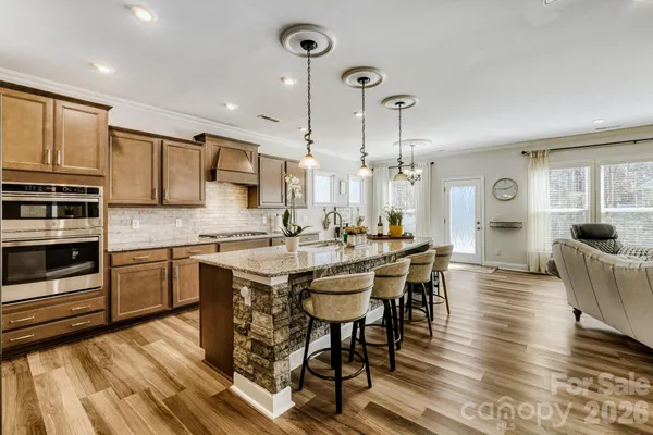 a kitchen with stainless steel appliances granite countertop a refrigerator and a sink