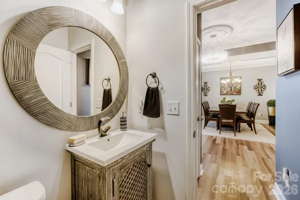 a bathroom with a sink a toilet a mirror and shower