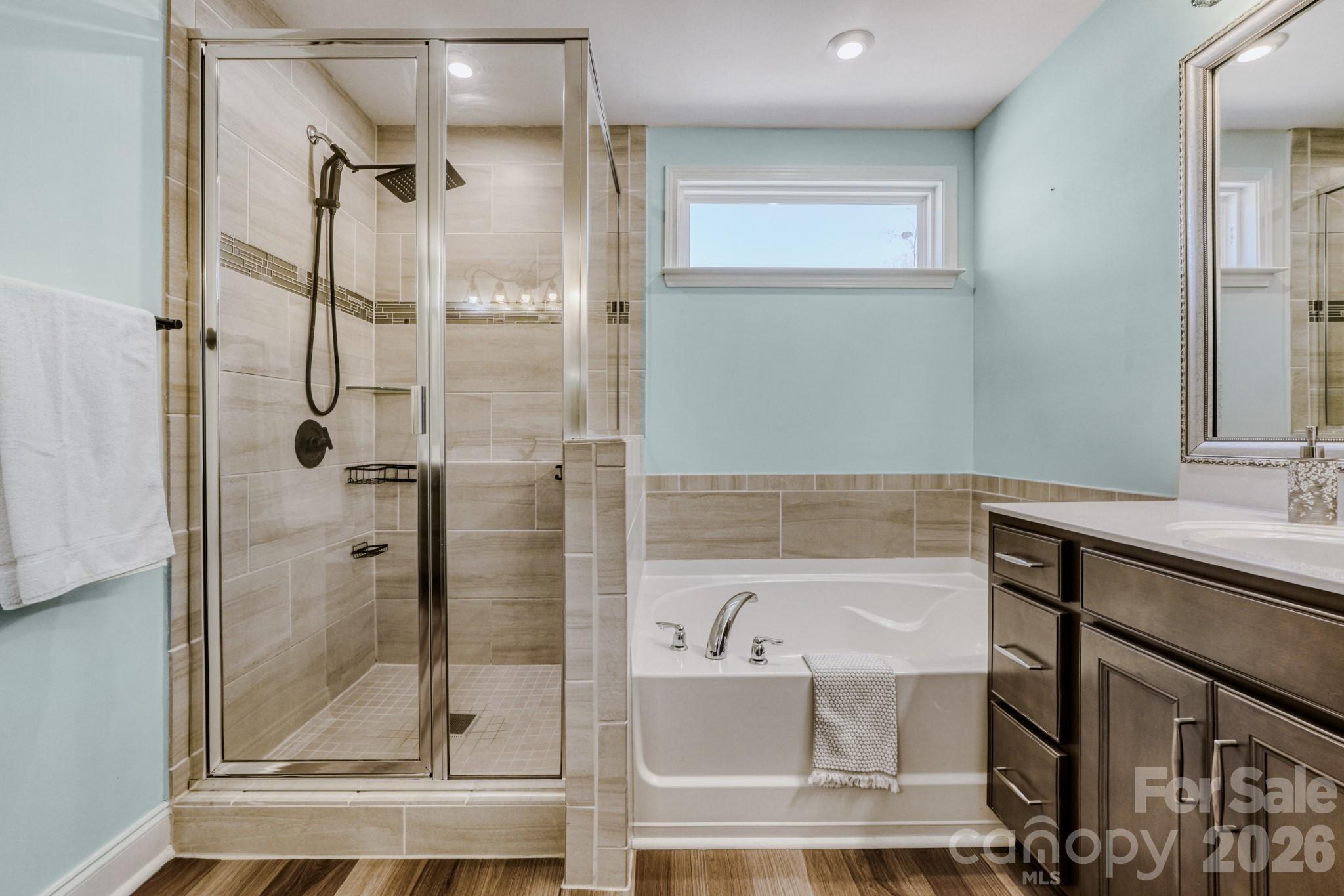 1318 Poppy Way Matthews, NC 28104 - Photo 19 of 33 a bathroom with a bathtub and a shower