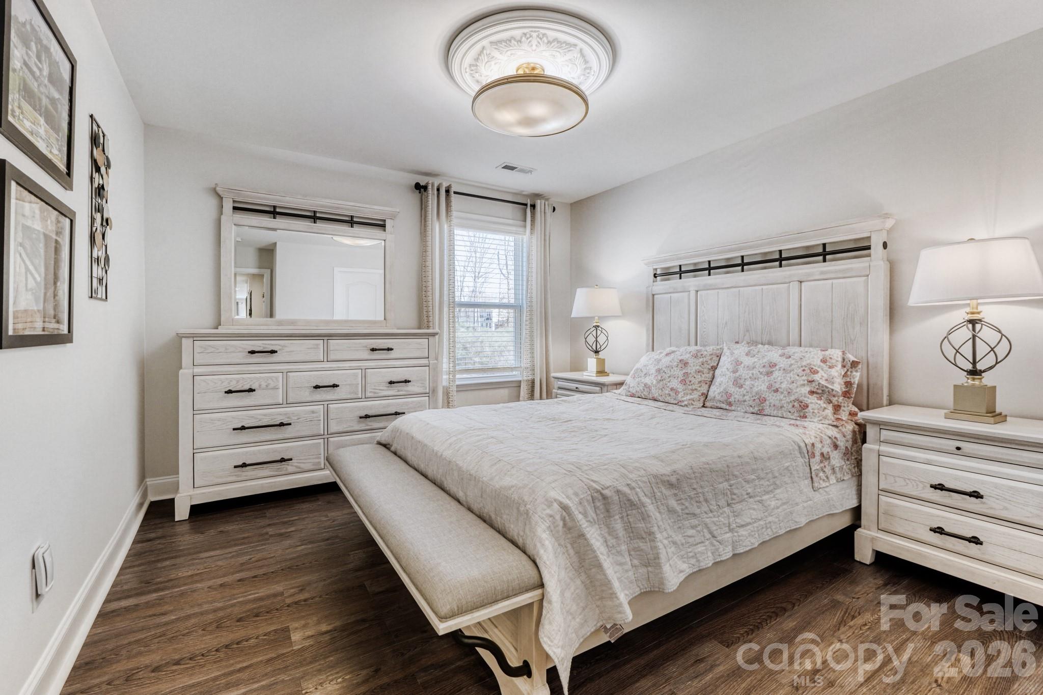 1318 Poppy Way Matthews, NC 28104 - Photo 20 of 33 a bedroom with a bed and wooden floor