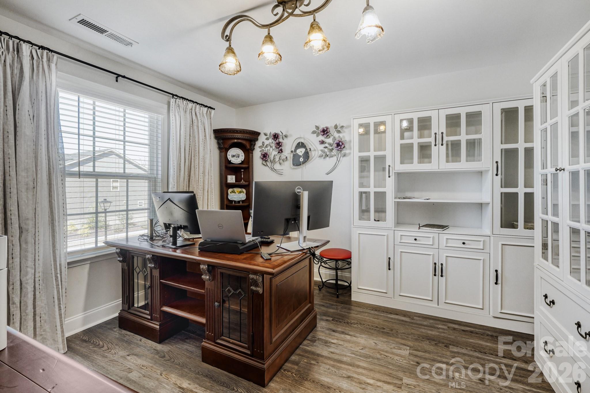 1318 Poppy Way Matthews, NC 28104 - Photo 22 of 33 a kitchen with stainless steel appliances a stove a sink dishwasher and cabinets with wooden floor