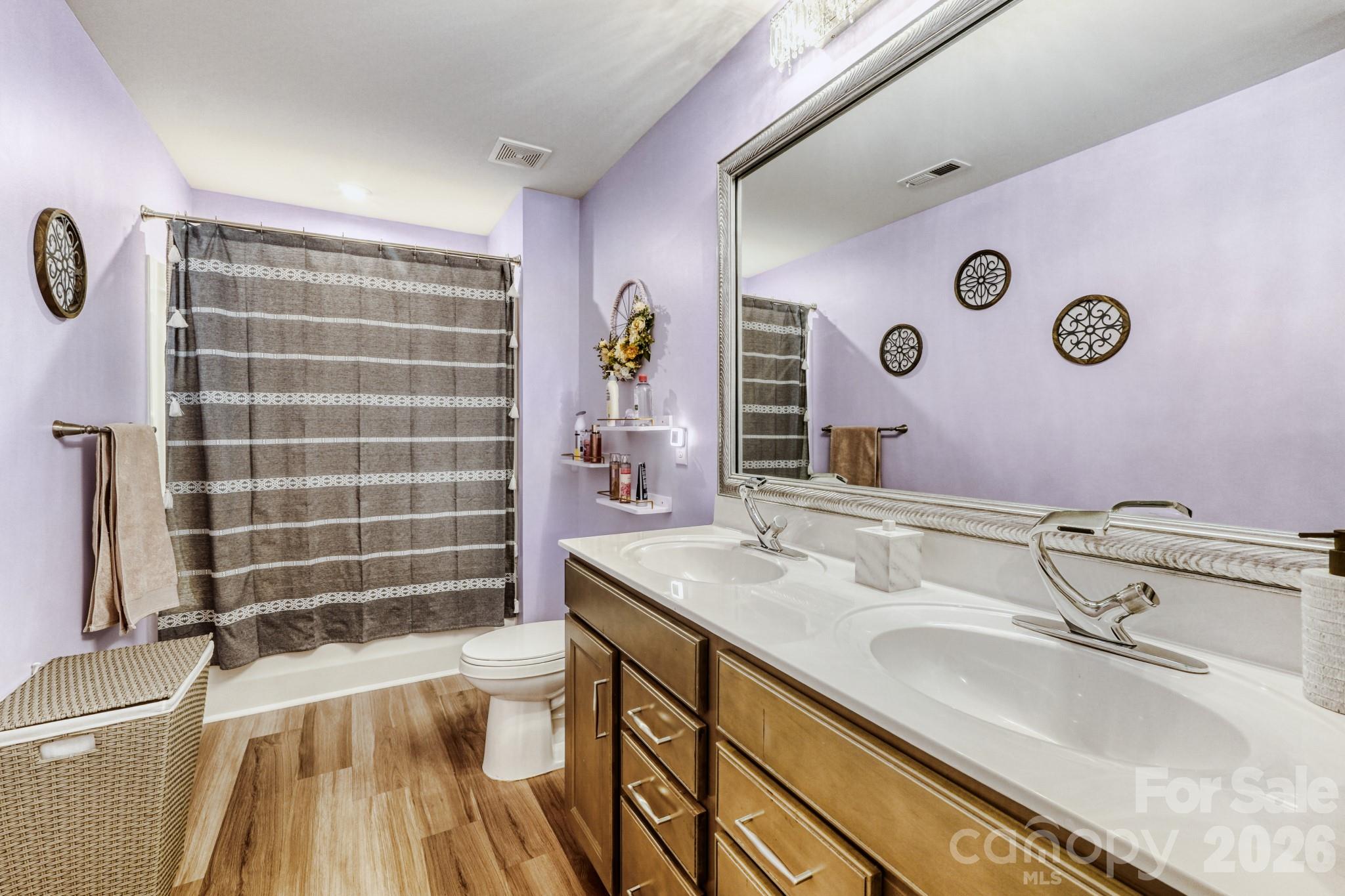 1318 Poppy Way Matthews, NC 28104 - Photo 23 of 33 a bathroom with a sink a toilet a mirror and shower