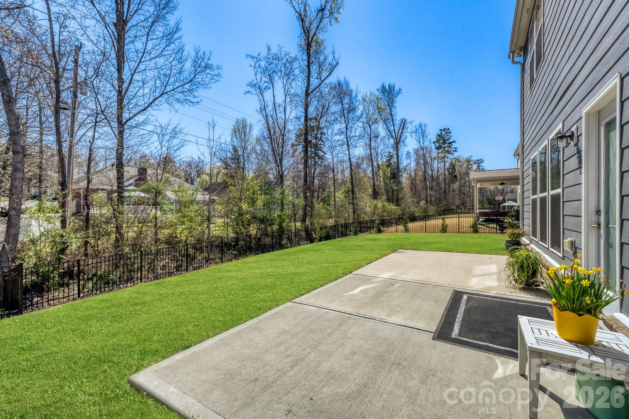 1318 Poppy Way Matthews, NC 28104 - Photo 27 of 33 a view of backyard with swimming pool and outdoor seating