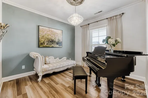 a living room with furniture a chandelier and a fireplace