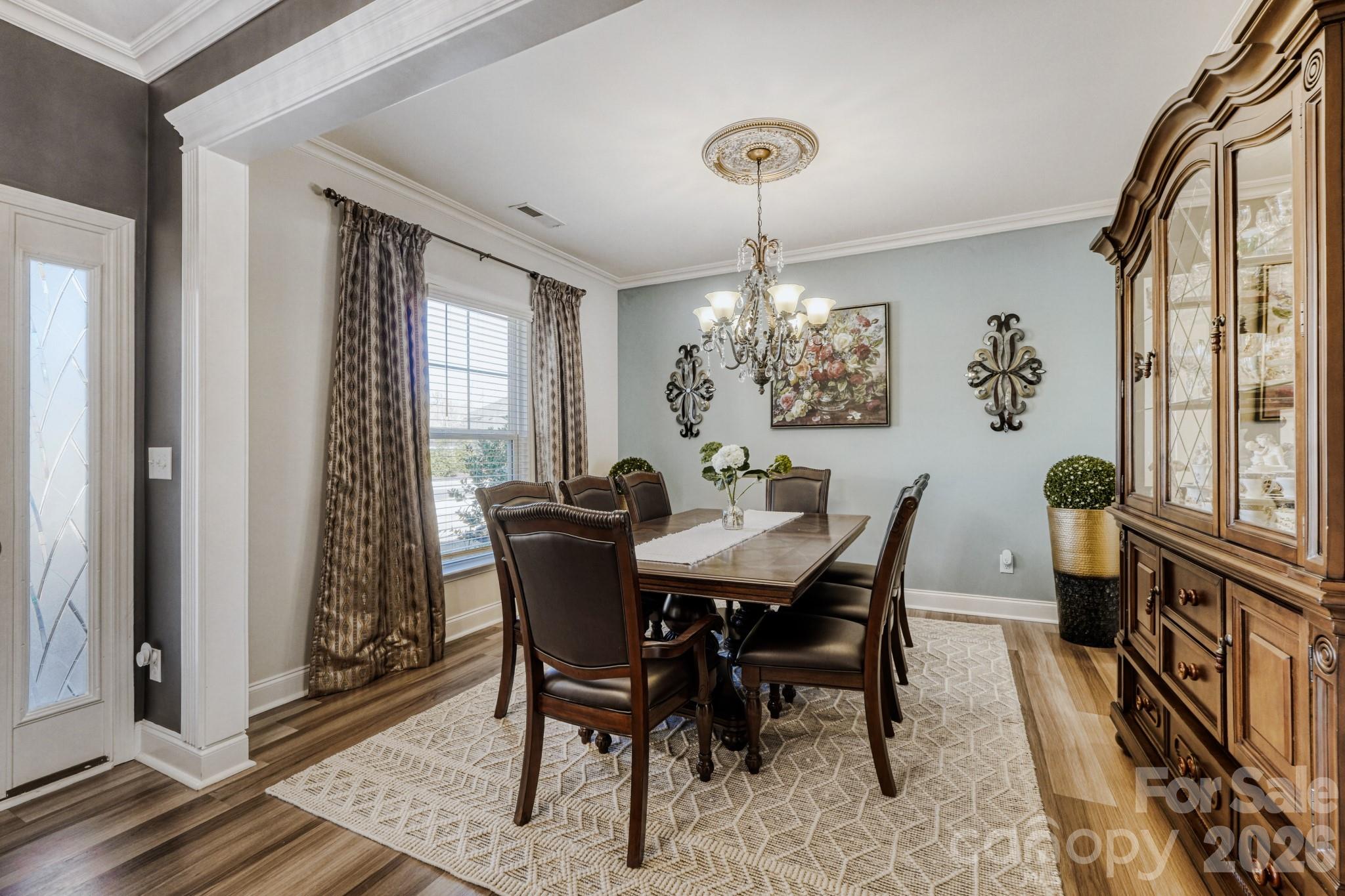 1318 Poppy Way Matthews, NC 28104 - Photo 5 of 33 a view of a dining room with furniture window and wooden floor