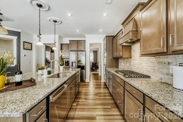 a kitchen with stainless steel appliances granite countertop a stove and a refrigerator
