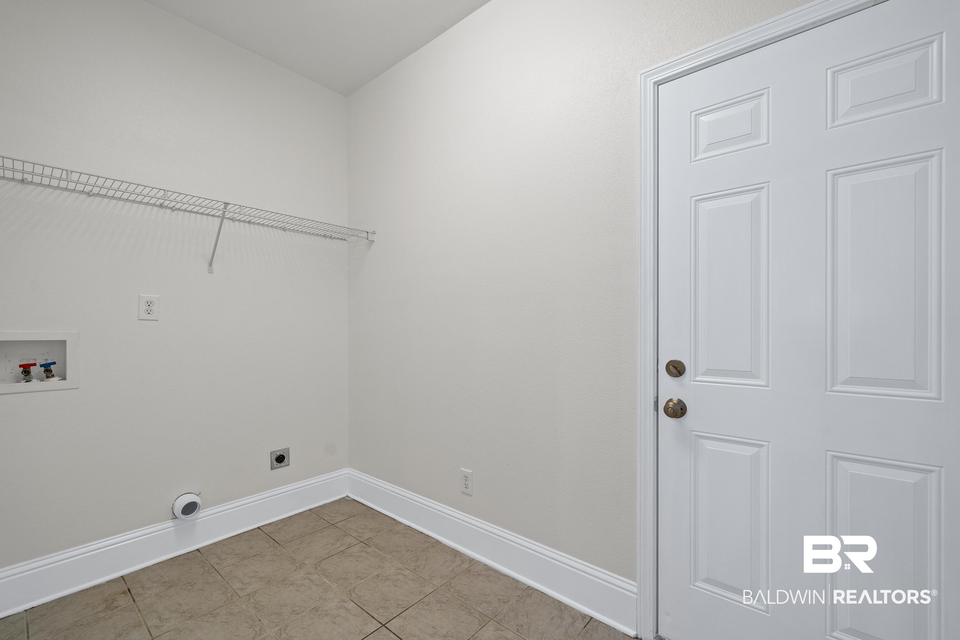 25350 Spindle Lane Daphne, AL 36526 - Photo 27 of 32 Clothes washing area with light tile patterned flooring, hookup for an electric dryer, and washer hookup