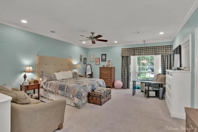 a spacious bedroom with a bed and a large window