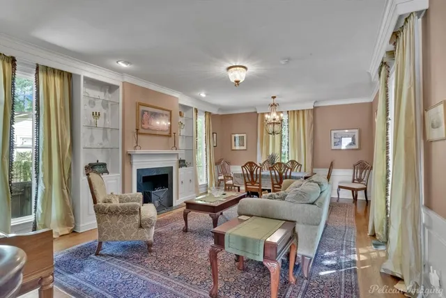 a living room with furniture fireplace and a large window
