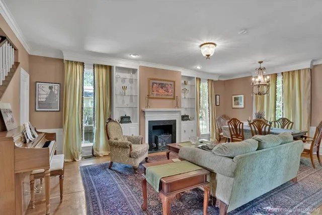 a living room with furniture fireplace and window
