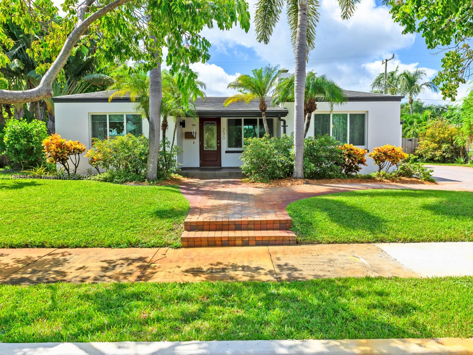 230 Beverly Road West Palm Beach, FL 33405 - Photo 3 of 47 a front view of a house with a yard