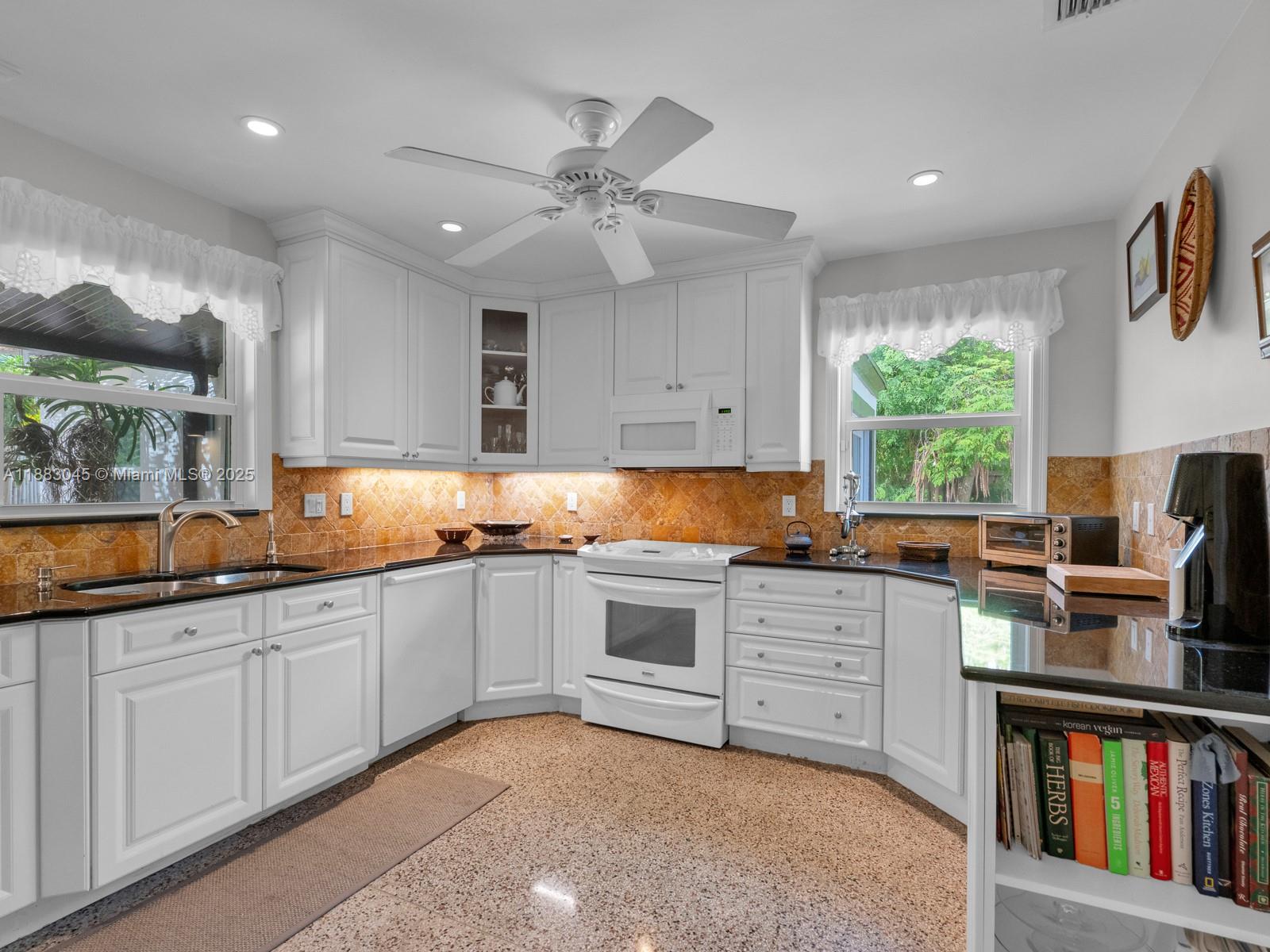 230 Beverly Road West Palm Beach, FL 33405 - Photo 7 of 47 a kitchen with white cabinets and window