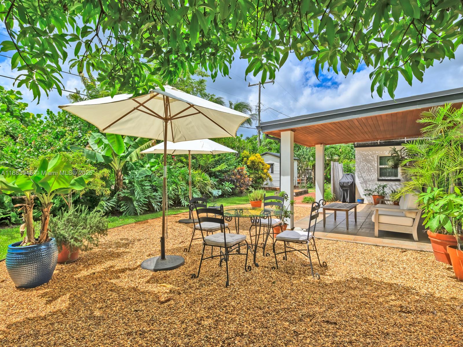 230 Beverly Road West Palm Beach, FL 33405 - Photo 10 of 47 a view of an outdoor sitting area with couch and umbrella