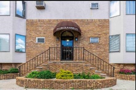 a view of entrance gate of a house with wooden wall