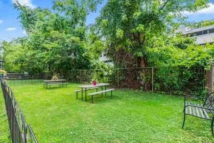 a view of backyard with sitting area and slide
