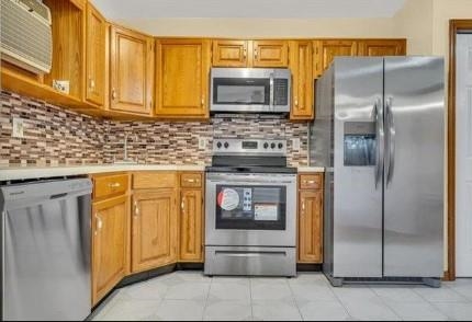 211-213 Prospect Avenue Bayonne, NJ 07002 - Photo 2 of 16 a kitchen with stainless steel appliances granite countertop a refrigerator and a stove top oven