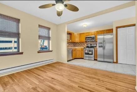 211-213 Prospect Avenue Bayonne, NJ 07002 - Photo 4 of 16 a view of a kitchen with a stove cabinets and wooden floor