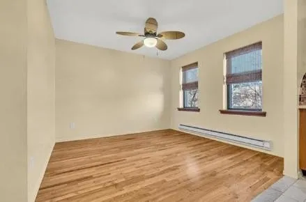 a view of an empty room with wooden floor
