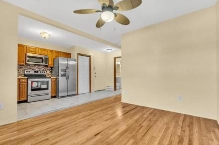 211-213 Prospect Avenue Bayonne, NJ 07002 - Photo 6 of 16 a view of a kitchen with a sink and a refrigerator