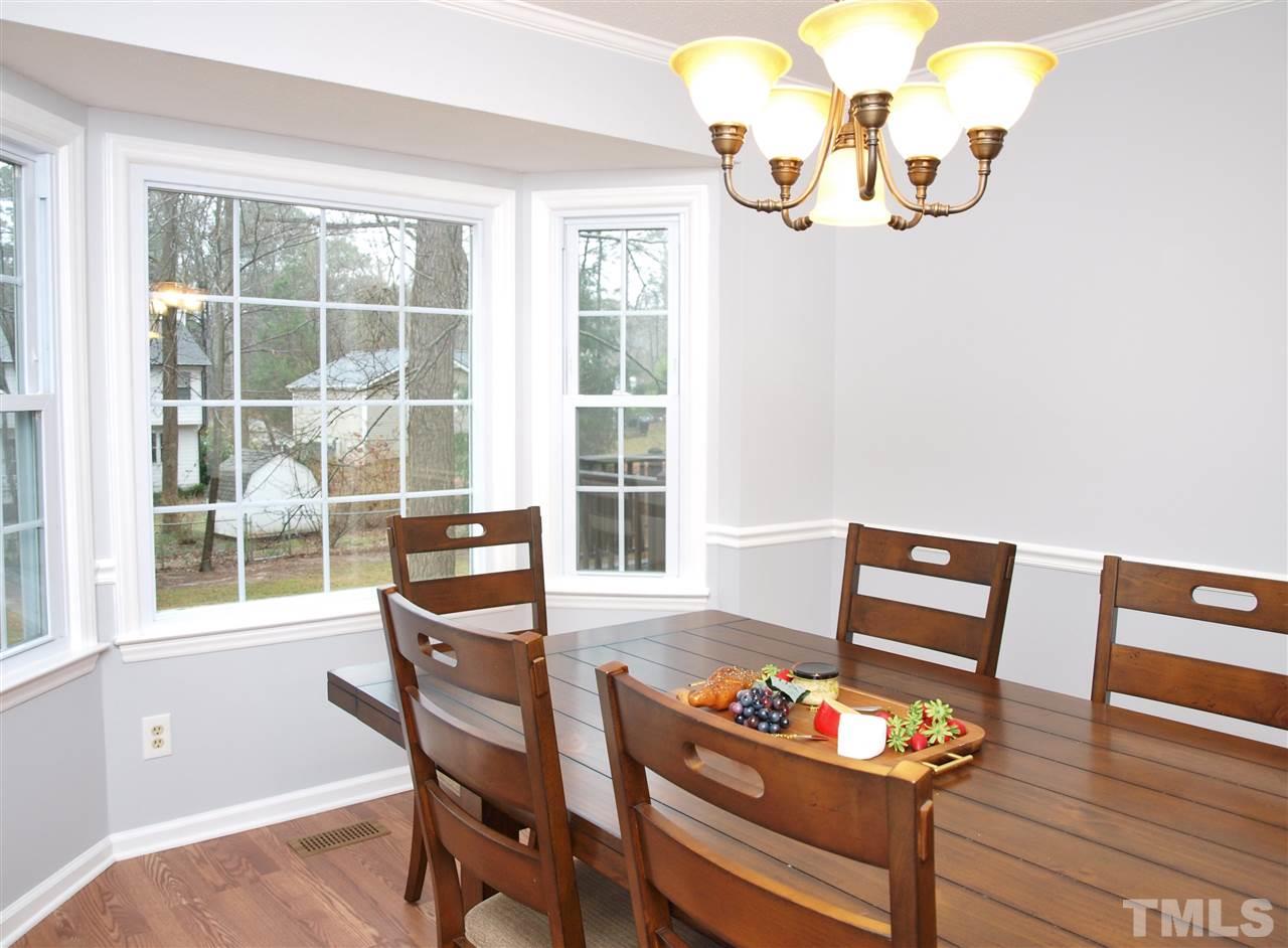 1117 Toppe Ridge Court Raleigh, NC 27615 - Photo 2 of 30 a dining room with furniture a window and wooden floor