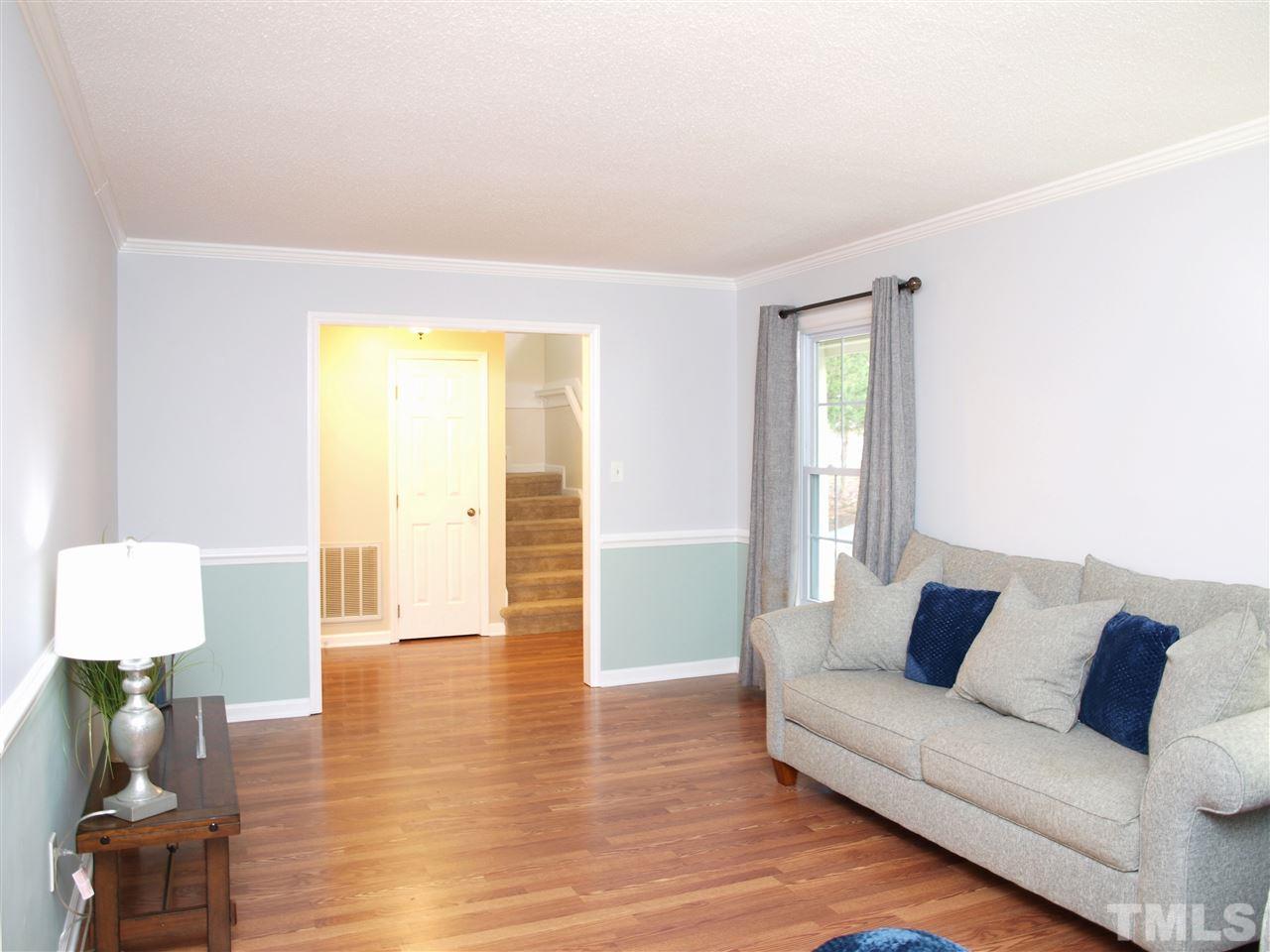 1117 Toppe Ridge Court Raleigh, NC 27615 - Photo 12 of 30 a living room with furniture and a wooden floor
