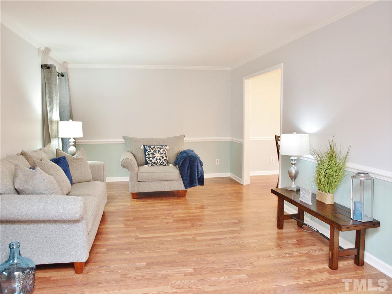 1117 Toppe Ridge Court Raleigh, NC 27615 - Photo 13 of 30 a living room with furniture and wooden floor
