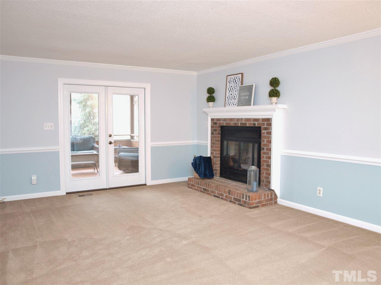 1117 Toppe Ridge Court Raleigh, NC 27615 - Photo 7 of 30 an empty room with windows and fireplace