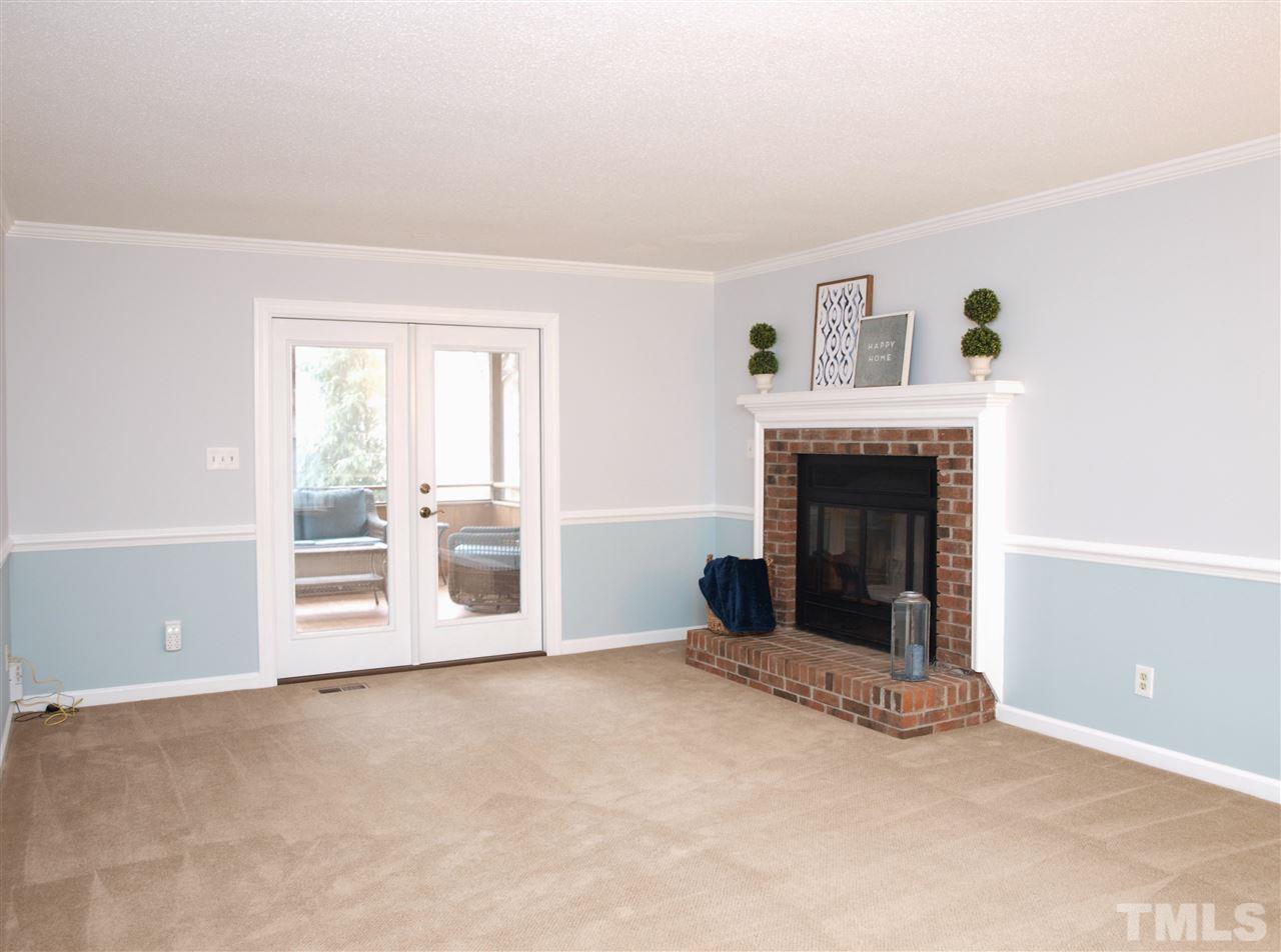 1117 Toppe Ridge Court Raleigh, NC 27615 - Photo 9 of 30 a view of an empty room with a fireplace and a window