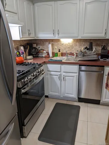 a kitchen with stainless steel appliances granite countertop a stove and a microwave