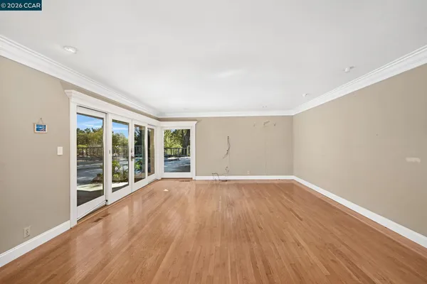 wooden floor in an empty room with a window
