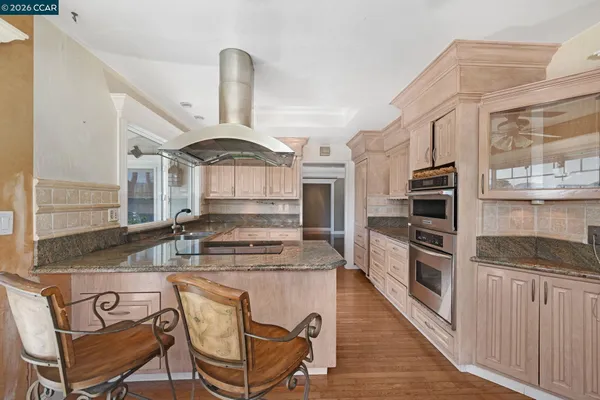 a kitchen with stainless steel appliances granite countertop a stove and a refrigerator