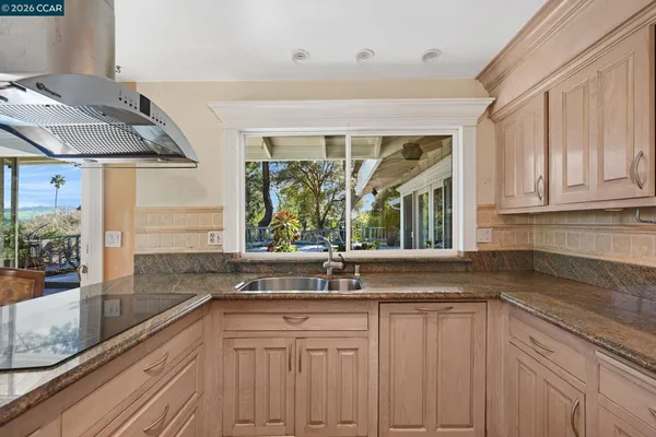 a kitchen with granite countertop a sink and a window