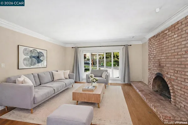 a living room with furniture large window and a fireplace