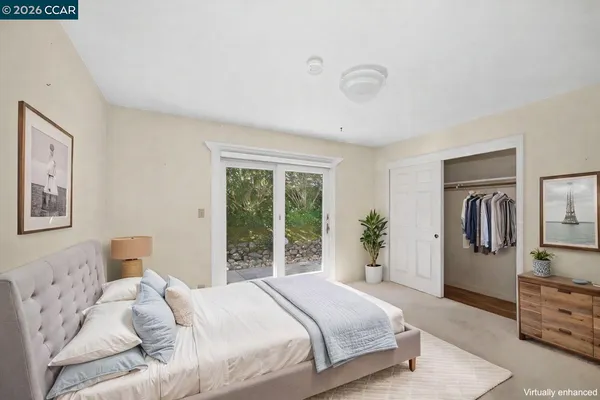 a bedroom with a large bed and a window