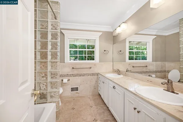 a bathroom with a sink double vanity and a mirror