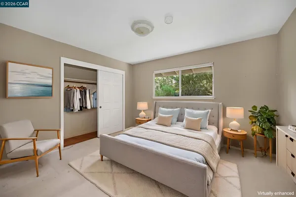 a bedroom with a large bed and a potted plant