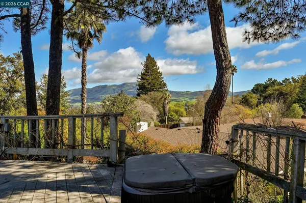 a view of balcony with wooden floor and fence