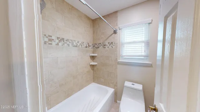 a bathroom with a shower and a toilet