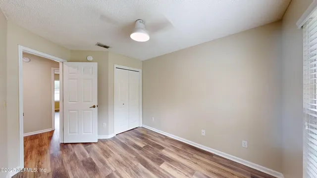 a view of hallway with wooden floor