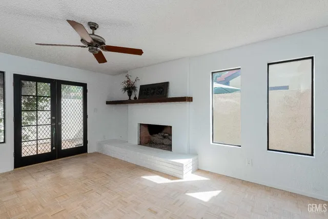 a view of a livingroom with a fireplace and window