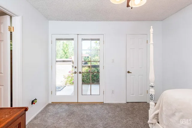 a view of a bedroom with a bed and glass door