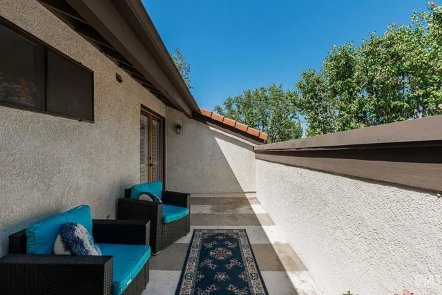 a view of balcony with couches and wooden floor