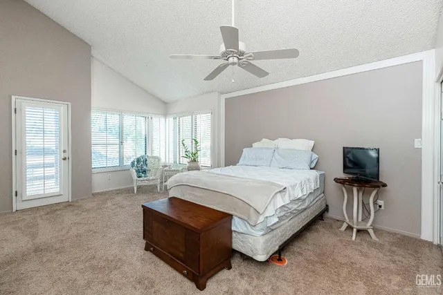 a spacious bedroom with a large bed and a large window