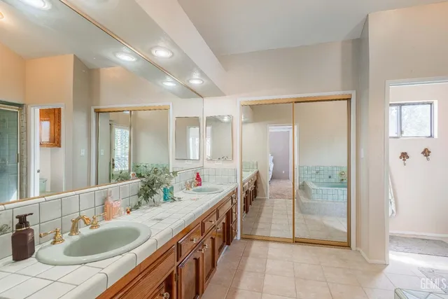 a bathroom with a tub shower and sink
