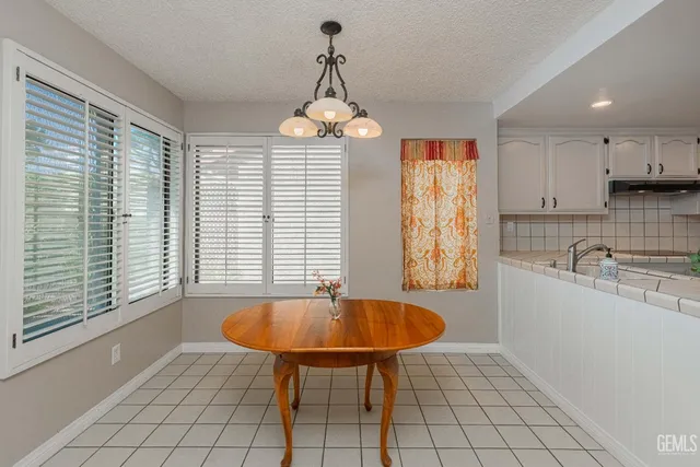 a kitchen with granite countertop a stove sink and cabinets